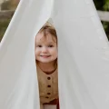 Picture of a happy child in a tent featured on the article for preschooler emotional development.