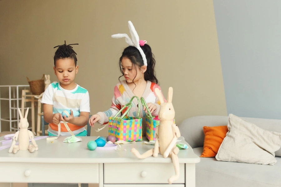 Two toddler enjoy decorating Easter eggs together, a fun Easter idea for toddlers. 