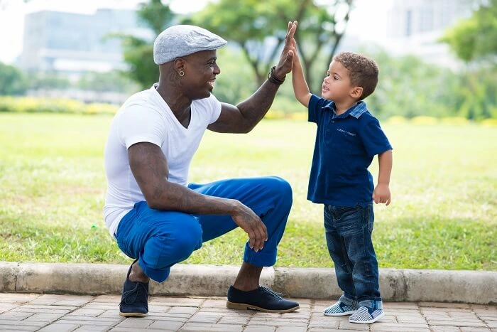 Father's Day crafts for preschoolers helps a father and son bond and share high fives, as pictured here. 