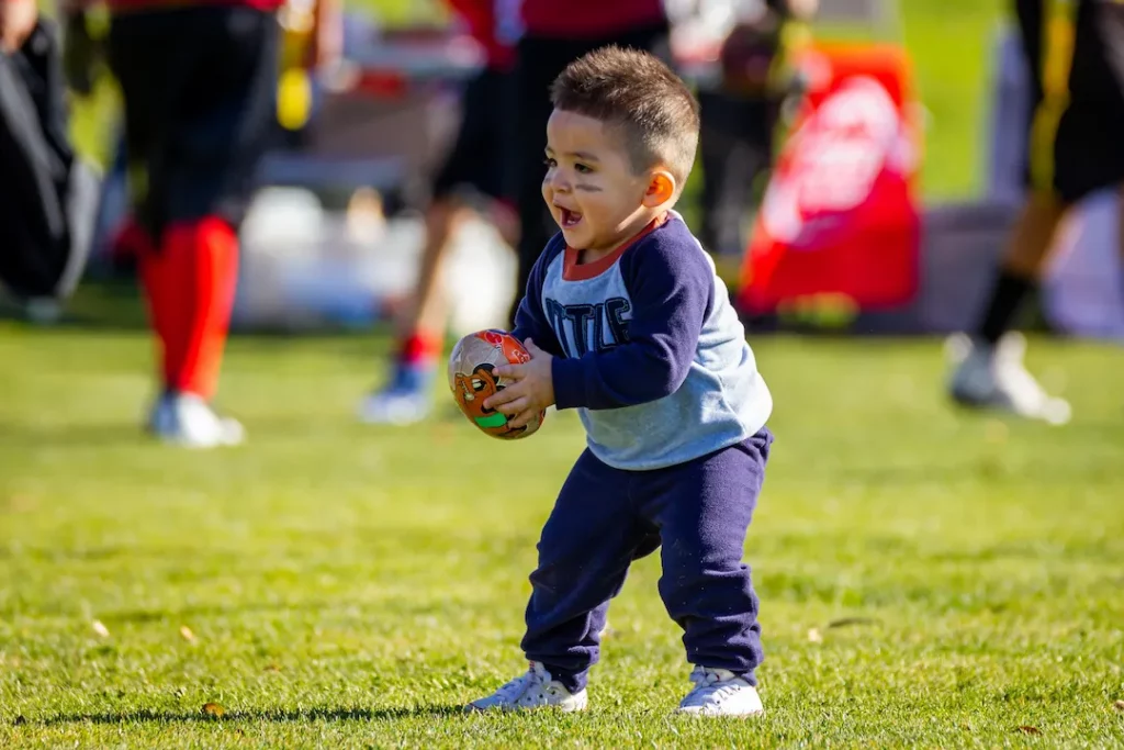 Sports activities for preschoolers includes a child playing with a ball, as pictured here. 