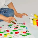 Finger painting as demonstrated by a child here is one back to school craft for toddlers to enjoy.