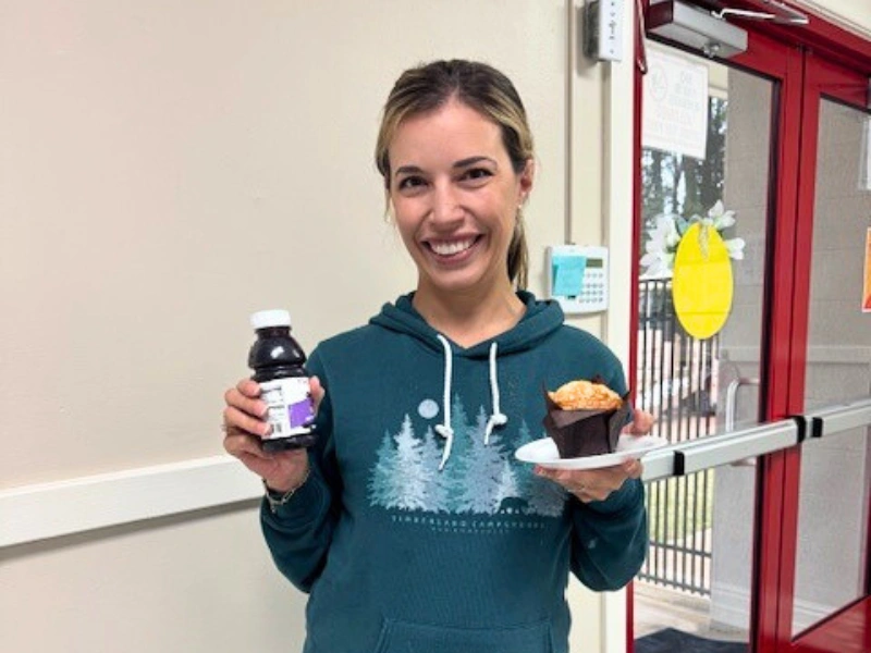 Mom holding juice and muffin. Image complements "Raleigh's preschool tour checklist."
