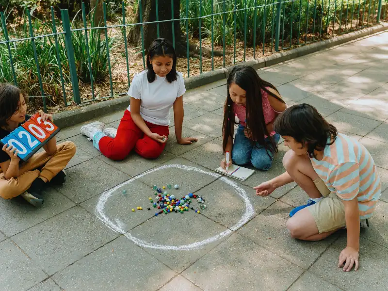 school aged children participate in active relays as part of outdoor stem activities. 
