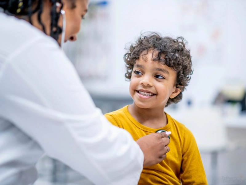 Child at doctor office getting heart rate checked. Part of the back to school checklist for parents.