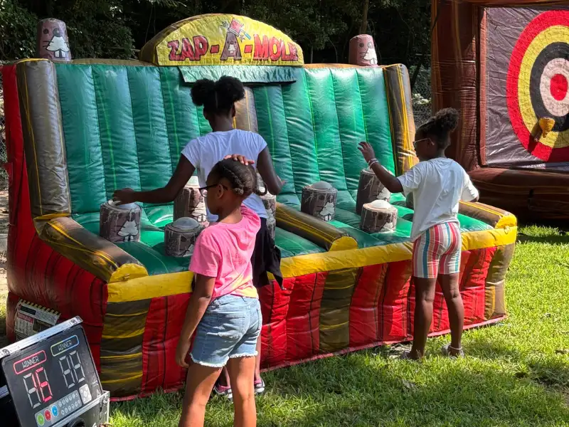 3 children playing an outdoor game. Image complements the blog "preschool tour checklist." 