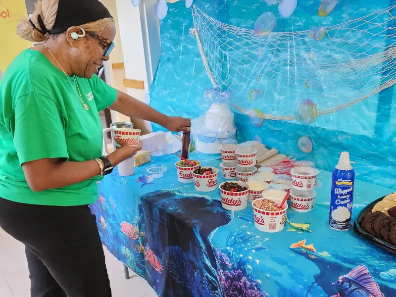 Female preparing custard in cups. Image complements the blog "preschool checklist."