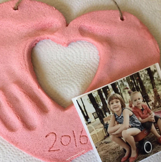 Pink heart-shaped frame with photo of kids. This image accompanies the blog title, "fathers day crafts for preschoolers." 