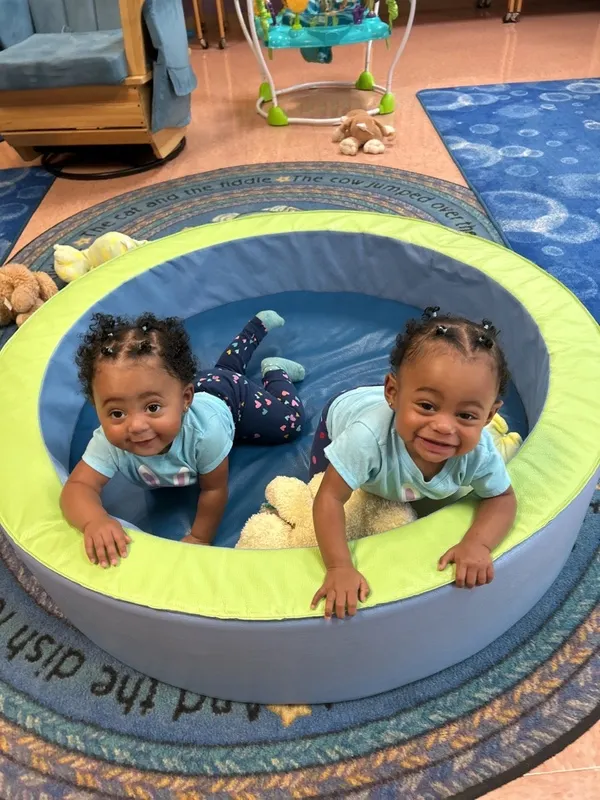 Two infants in a classroom. infant day care raleigh nc, infant care, infant care near me, infant care raleigh, raleigh infant care.