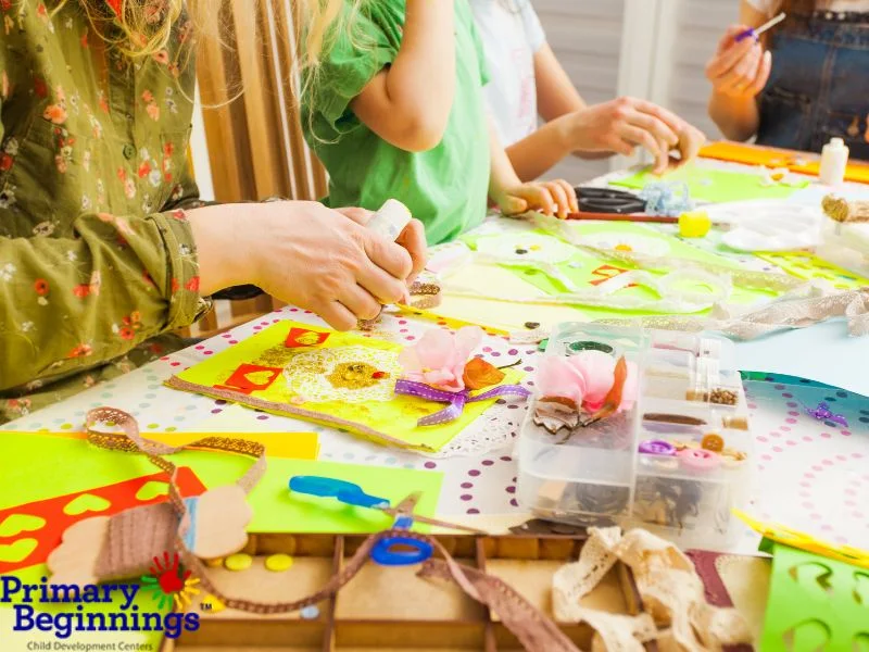 A mom and child work together to make infant mother's day crafts