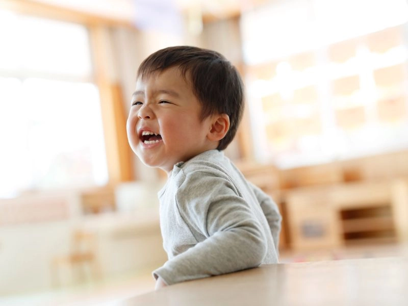 music for preschoolers for confidence as shown here by a young boy smiling.