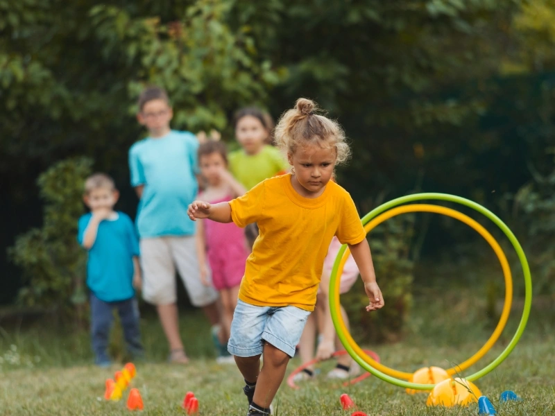 children outside playing, complementing the blog "nature activities for kids."