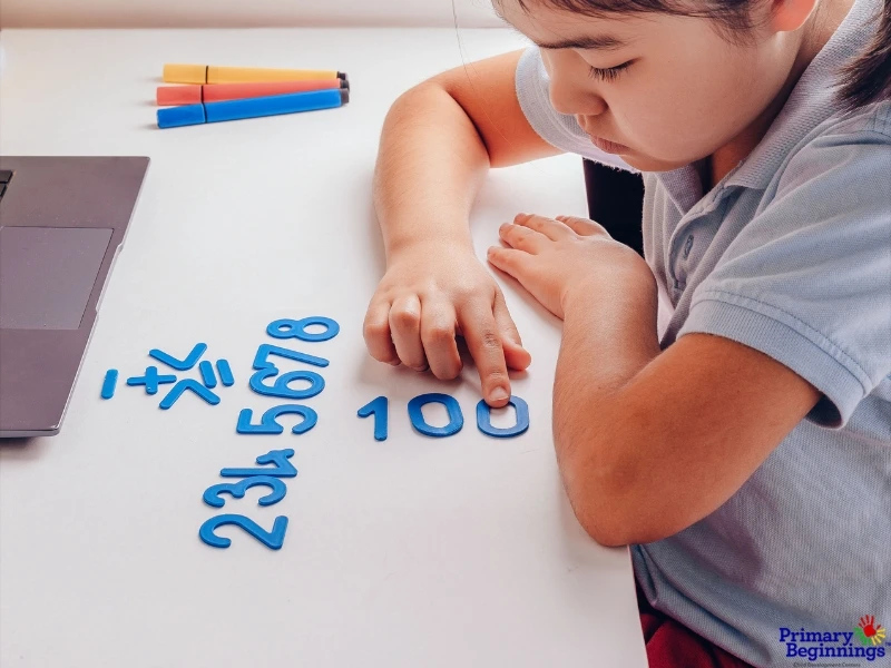 A young girl plays with numbers. This image accompanies the blog post, "Outdoor Math Games for Kindergarten." 