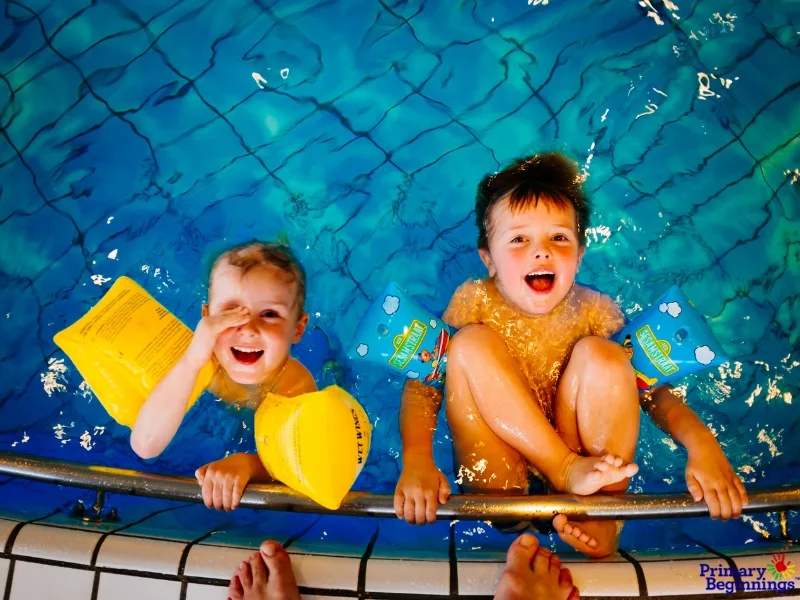 Two young male children in a pool. This image accompanies the blog titled, "Outdoor math games for preschoolers."