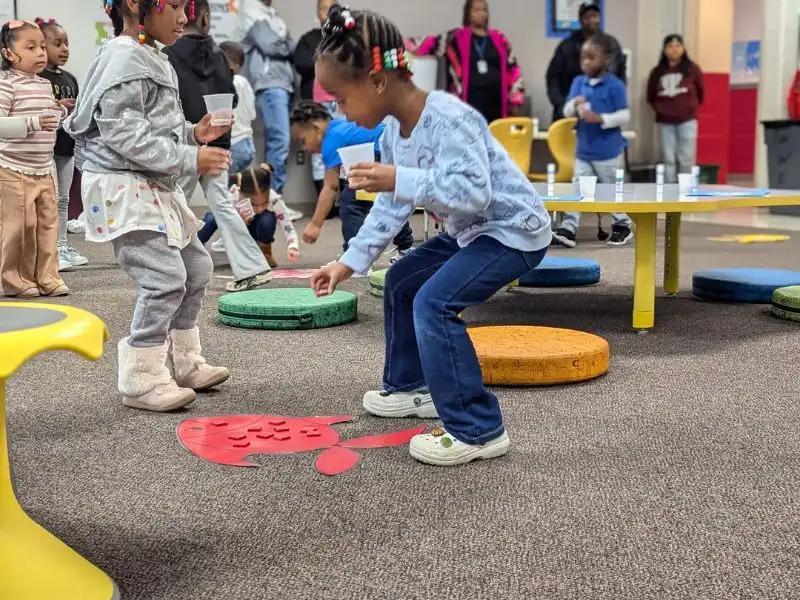 A teacher is teaching problem solving for preschoolers with an active game.