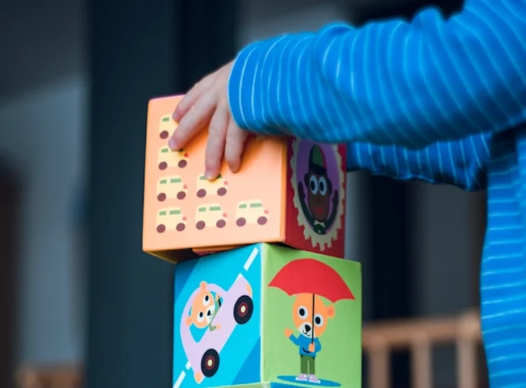 Toddler using building blocks. toddler day care, toddler care, toddler daycare, toddler program, childcare for toddlers.