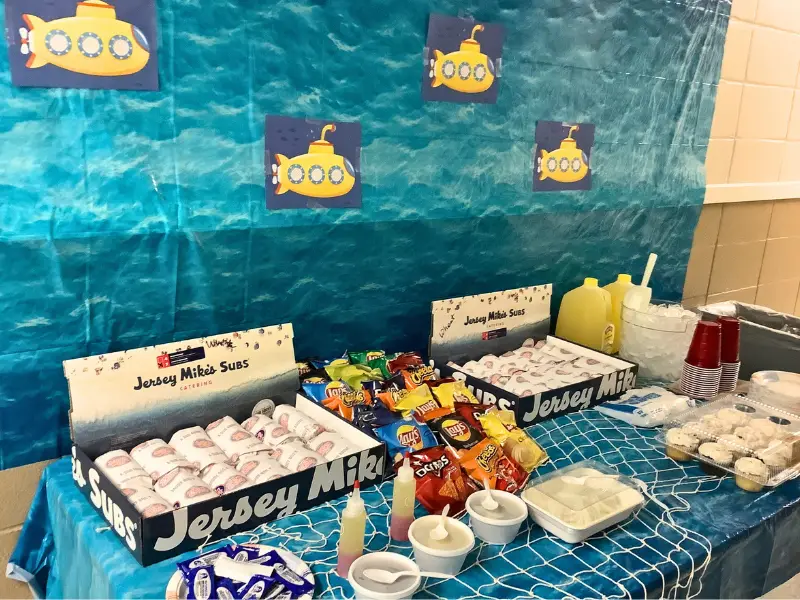 Table of subs and chips. Image complements the blog "your go to preschool tour checklist." 